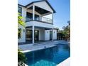Inviting swimming pool, spacious deck, and a two-story home in the background at 2311 Grove St, Sarasota, FL 34239