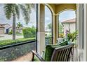 Relaxing screened porch with comfortable seating and a view of the neighborhood at 23463 Copperleaf Dr, Venice, FL 34293