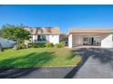 Front view of villa with carport and landscaping at 2505 Riverbluff Pkwy # V196, Sarasota, FL 34231