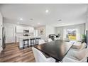 Open concept kitchen and dining area with an island and modern appliances at 3408 Hilltop Cir, Bradenton, FL 34211