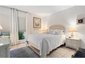 Bright bedroom with a comfortable queen-size bed and wicker furniture at 3421 Clark Rd # 122, Sarasota, FL 34231