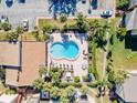 Inviting kidney-shaped pool with lounge chairs and patio furniture at 3421 Clark Rd # 122, Sarasota, FL 34231