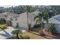 House with 3-car garage and solar panels, surrounded by palm trees at 3439 101St E Ave, Parrish, FL 34219