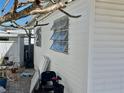 Side view of single story home with three awning windows and an outdoor seating area at 3710 Gulf Of Mexico Dr # D19, Longboat Key, FL 34228