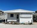 Single-story home with covered porch, awning, showcasing a functional and inviting outdoor living area at 3710 Gulf Of Mexico Dr # D19, Longboat Key, FL 34228