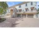 Elegant home featuring a three-car garage and inviting staircase at 4136 Roberts Point Cir, Sarasota, FL 34242