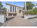 Stunning waterfront home with a grand entrance and palm trees at 4136 Roberts Point Cir, Sarasota, FL 34242