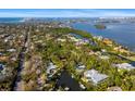 Aerial view showcasing home's waterfront location and surrounding area at 5112 Jungle Plum Rd, Sarasota, FL 34242