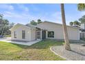 Tan house with a screened porch and palm trees at 5384 Sarapointe Ct, Sarasota, FL 34232