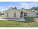 Tan house with a screened porch and well-manicured lawn at 5384 Sarapointe Ct, Sarasota, FL 34232
