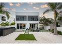 Spacious backyard oasis with a spa, patio, and lounge chairs at 5906 Larchwood Ave, Sarasota, FL 34231