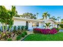 Landscaped front yard with a white single story house at 6726 S Lockwood Ridge Rd, Sarasota, FL 34231