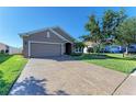 House exterior boasts a well-manicured lawn and a large driveway at 7923 111Th E Ter, Parrish, FL 34219