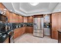 Modern kitchen with stainless steel appliances and wood cabinets at 888 Blvd Of The Arts # 1408, Sarasota, FL 34236