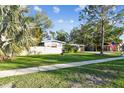 House exterior showcasing a well-manicured lawn and American flag at 1100 27Th W Ave, Palmetto, FL 34221