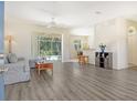 Bright living room featuring wood-look floors and view of pool at 1447 Allegheny Ln, North Port, FL 34286