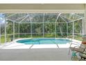 Relaxing screened-in pool area with patio furniture at 1447 Allegheny Ln, North Port, FL 34286