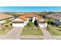 Two-story house with tile roof, two-car garage, and landscaped yard at 1810 5Th E St, Palmetto, FL 34221