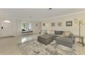 Spacious living room with grey sectional sofa and large windows at 2708 Bigelow Dr, Sarasota, FL 34239