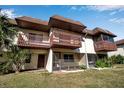 Rear view of townhome showing another balcony and landscaping at 3212 Ramblewood N Dr # 3212, Sarasota, FL 34237