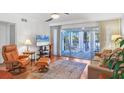 Living room with hardwood floors and access to balcony at 3300 S Beneva Rd # 224, Sarasota, FL 34232