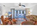 Living room with hardwood floors and access to balcony at 3300 S Beneva Rd # 224, Sarasota, FL 34232