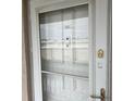 Condo building entry door with security features at 3983 Maceachen Blvd # 432, Sarasota, FL 34233