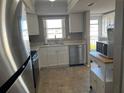 White kitchen cabinets, stainless steel appliances and microwave at 3983 Maceachen Blvd # 432, Sarasota, FL 34233
