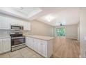 Modern kitchen with stainless steel appliances and white cabinets at 4275 Castlebridge Ln # 1312B1, Sarasota, FL 34238
