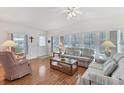 Spacious living room with light wood floors, comfortable seating, and large windows at 4316 12Th Street E Ct, Ellenton, FL 34222