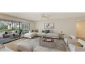 Spacious living room with sectional sofa, sliding glass doors, and patio access at 5152 Marsh Field Ln # 117, Sarasota, FL 34235