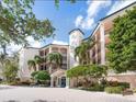 Attractive building exterior with landscaping and courtyard at 5440 Eagles Point Cir # 405, Sarasota, FL 34231