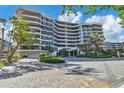 Elegant beachfront condo building with landscaped grounds and courtyard at 545 Sanctuary Dr # A803, Longboat Key, FL 34228