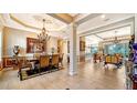 Elegant formal dining room featuring a chandelier and hardwood floors at 6337 Rivo Lakes Blvd, Sarasota, FL 34241