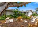 Landscaped front yard with stone path and lush greenery at 6706 22Nd W Ave, Bradenton, FL 34209