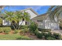 Landscaped house exterior featuring lush greenery at 7121 Victoria Cir, University Park, FL 34201