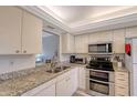 Galley kitchen with stainless steel appliances and granite counters at 7130 Fairway Bend Ln # 193, Sarasota, FL 34243
