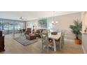 Living room with dining area, hardwood floors, and patio access at 7130 Fairway Bend Ln # 193, Sarasota, FL 34243