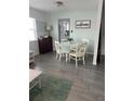 Small dining area with white table and chairs, view into kitchen at 935 Rhodes Ave, Sarasota, FL 34237