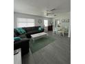 Spacious living room with sectional sofa, dining area, and tile floors at 935 Rhodes Ave, Sarasota, FL 34237