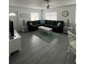 Bright living room featuring a large sectional sofa and tile floors at 935 Rhodes Ave, Sarasota, FL 34237