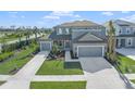 Two-story house with two-car garage, landscaping, and driveway at 9511 Tequila Sunrise Dr, Sarasota, FL 34241
