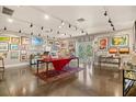 Spacious art-filled gallery with hardwood floors and track lighting at 1110 12Th W St, Bradenton, FL 34205