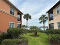 Waterfront view between two buildings, palm trees and green grass at 1139 Riverscape St # 2D, Bradenton, FL 34208