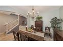 Formal dining room with a wood table, chandelier, and antique furniture at 15812 High Bell Pl, Bradenton, FL 34212