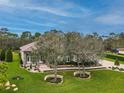 House with lush landscaping and driveway at 22343 Panther Loop, Bradenton, FL 34202