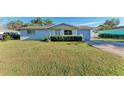 Light blue house with a spacious lawn and attached garage at 2915 Bucida Dr, Sarasota, FL 34232