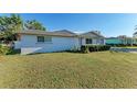 Single story home with a large grassy yard and attached garage at 2915 Bucida Dr, Sarasota, FL 34232