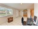Bright living room with large window, wood cabinet and computer at 2915 Bucida Dr, Sarasota, FL 34232