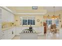 Bright kitchen featuring white cabinets and a center island at 2973 Longleat Woods, Sarasota, FL 34235